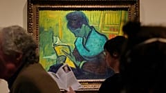 Visitors file past the Van Gogh painting "Une Liseuse De Romans", also known as "The Novel Reader"