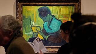 Visitors file past the Van Gogh painting "Une Liseuse De Romans", also known as "The Novel Reader"