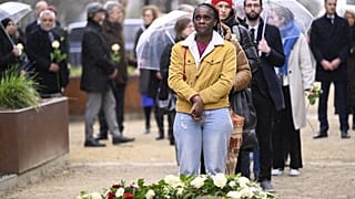 People take part in a ceremony at the memorial monument in the Brussels Wetstraat- rue de la Loi.