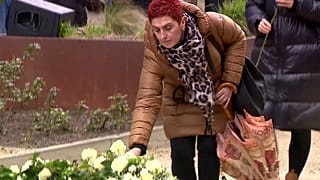 People take part in a ceremony at the memorial monument in the Brussels 
