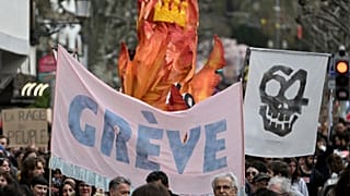 Protestors hold a banner reading "Strike" during a demonstration in Paris, France, 23 March 2023