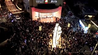 Palestinian Muslims gather in front of the City Hall in Ramallah in preparation for Ramadan