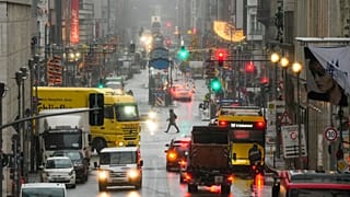 People cross the shopping street Friedrichstrasse in central Berlin.