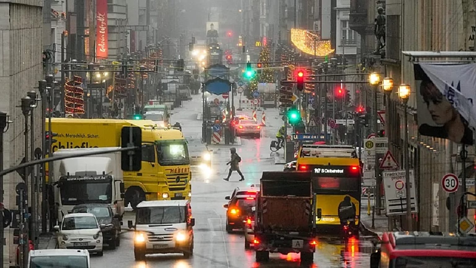 People cross the shopping street Friedrichstrasse in central Berlin.   -