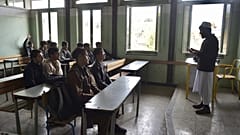 Afghan school boys attend their first classes at Esteqlal High School in Kabul on March 25, 2023, after missing the official start of the new academic year