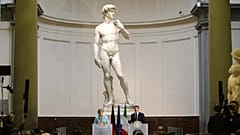 Former German Chancellor Angela Merkel and ex-Italian Prime Minister Matteo Renzi holding a press conference in front of Michelangelo's David in 2015.   -