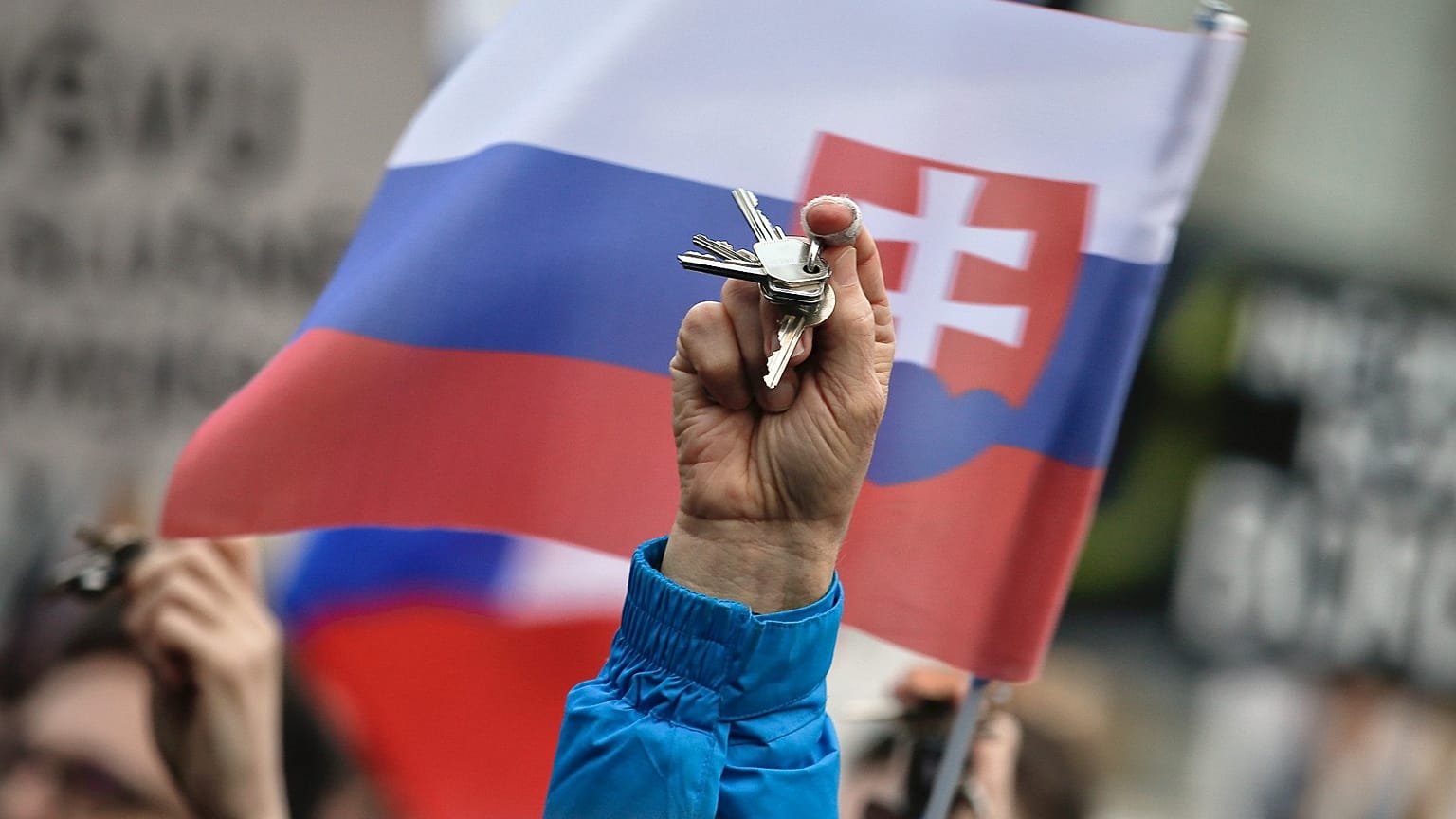 People rattle keys as they celebrate the resignation of Prime Minister Robert Fico and his government during a rally in Bratislava, 16 March 2018