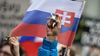 People rattle keys as they celebrate the resignation of Prime Minister Robert Fico and his government during a rally in Bratislava, 16 March 2018