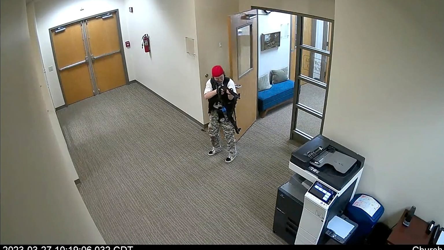 In this screen grab from surveillance video from the Metropolitan Nashville Police Department, Audrey Hale, points an assault-style weapon inside The Covenant School.