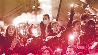 Protesters listen to a speaker during a rally near the Georgian parliament building in Tbilisi, 9 March 2023