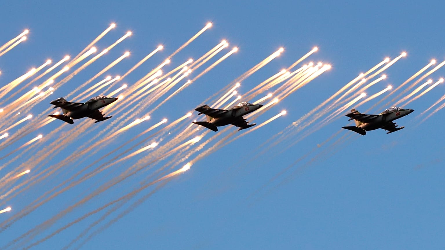 FILE - Su-25 fighters of the Belarusian army fly during a parade to mark Independence Day in Minsk, Belarus, Wednesday, July 3, 2019.