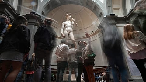 Tourists take photos in front of Michelangelo's "David statue" in the Accademia Gallery in Florence, Italy.