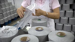 Eine Arbeiterin einer Textilfabrik während einer von der Regierung organisierten Reise für ausländische Journalisten in der autonomen Region Xinjiang-Uigurien, April 2021.