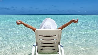 Someone relaxing on a beach.