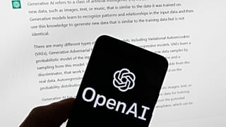The OpenAI logo is seen on a mobile phone in front of a computer screen displaying output from ChatGPT, Tuesday, March 21, 2023, in Boston, USA.
