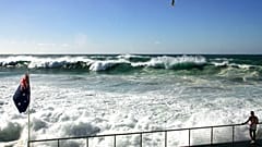 FILE - A man watches as waves roll in towards Bondi Beach in Sydney, Australia, April 9, 2006.