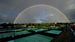 A rainbow arches in the sky as seen from the courts on day four of the Wimbledon tennis championships in London, Thursday, June 30, 2022.
