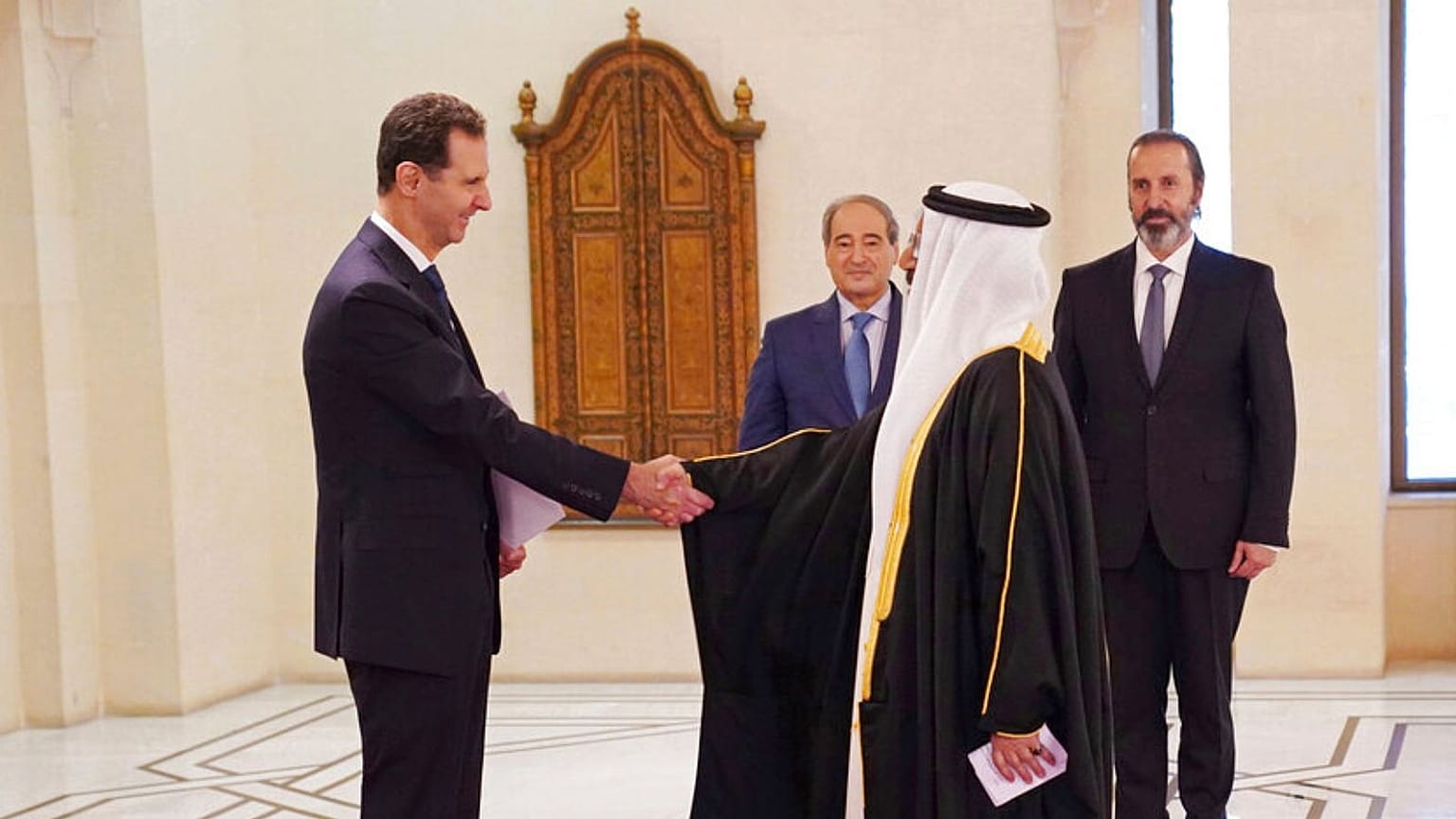 Bashar Assad shakes hands with Bahrain's new Ambassador to Syria, June 2022