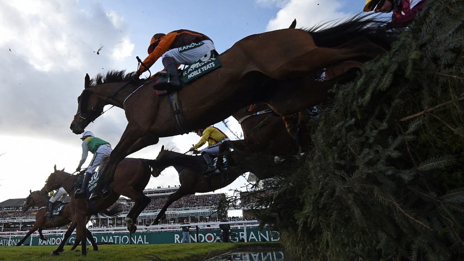 Riders on the final day of the Grand National Festival horse race meeting at Aintree Racecourse in Liverpool in 2022. 