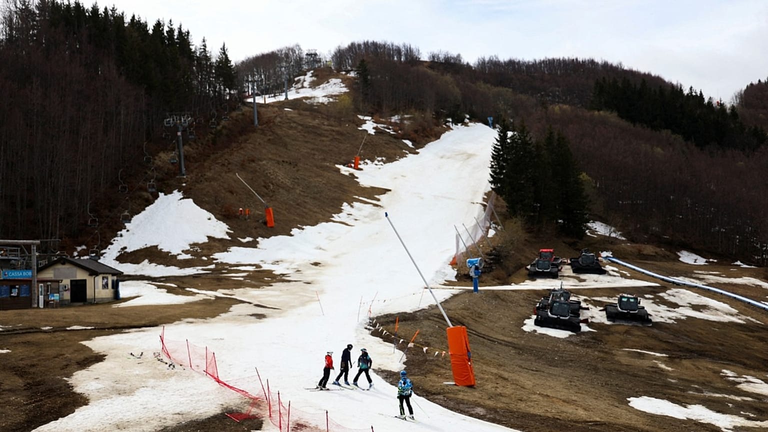 Skiers stand on an artificial snow slope as end of the ski season nears in Monte Cimone, Italy, 31 March 2023. 