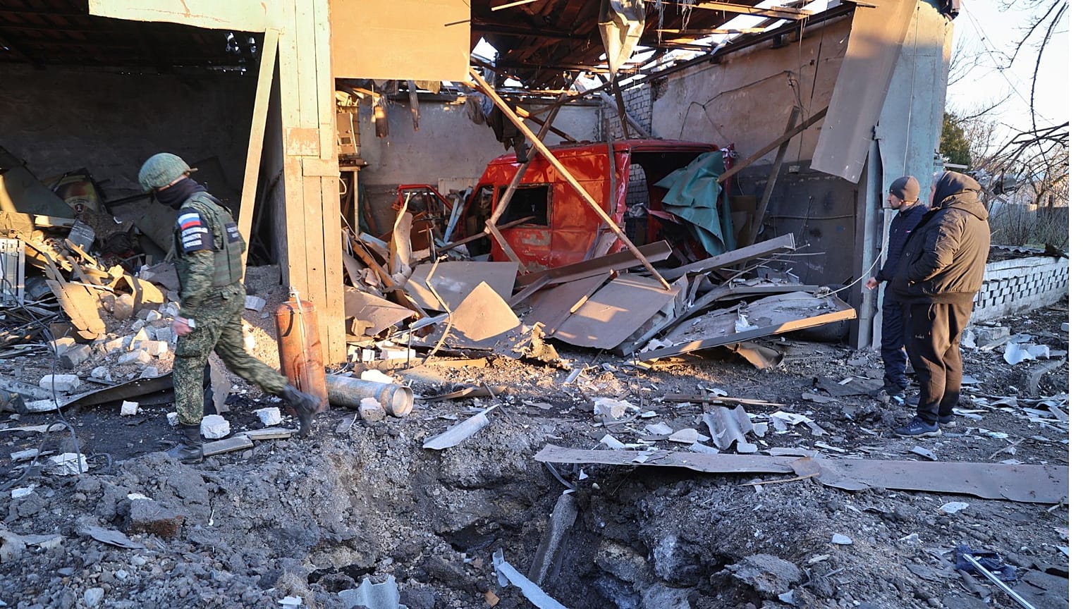 Investigators examine an explosion site near a shopping center, in what Russian officials in Donetsk allege was caused by shelling by Ukrainian forces, in Volnovakha