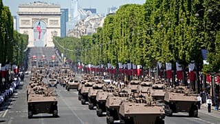 French servicemen drive Griffon multirole armoured vehicle during the Bastille Day military parade on the Champs-Élysées avenue in Paris on July 14, 2022.