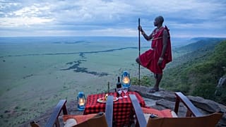 Un homme se tient près d'une table de pique-nique sur une montagne, Kenya