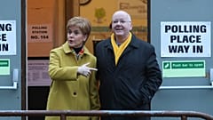 FILE: Former Scottish First Minister Nicola Sturgeon poses for the media with husband Peter Murrell, outside polling station in Glasgow, Scotland, December 2019