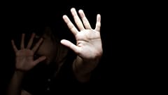A person holds their hands up in defence 