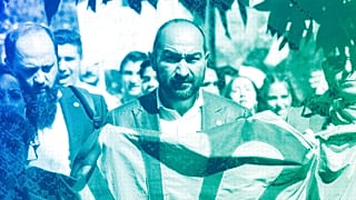 Željko Jovanović holds the Roma flag during an anti-racism march celebrating the Romani Resistance Day in Bucharest, 18 May 2019