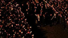 Faithful hold the cross as they take part in the Way of the Cross  procession at the Colosseum on Good Friday, in Rome, Friday, April 7, 2023