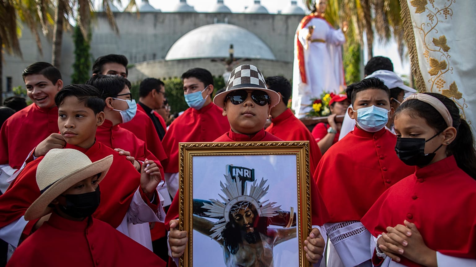 Altar servers take part in an event marking Good Friday at the Metropolitan Cathedral in Managua, Nicaragua.