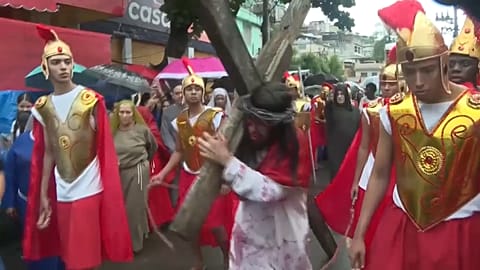Actors dressed as Roman soldiers as Jesus being brought to the stage in Rio, Brazil. 