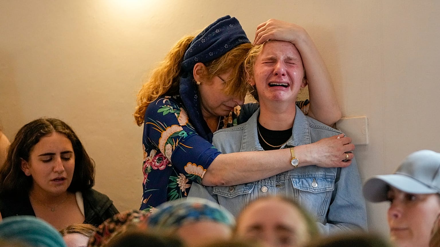 Mourners attend the funeral of two British-Israeli sisters, Maia and Rina Dee, at a cemetery in the Jewish settlement of Kfar Etzion in the occupied West Bank, Sunday, April 9