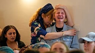 Mourners attend the funeral of two British-Israeli sisters, Maia and Rina Dee, at a cemetery in the Jewish settlement of Kfar Etzion in the occupied West Bank, Sunday, April 9