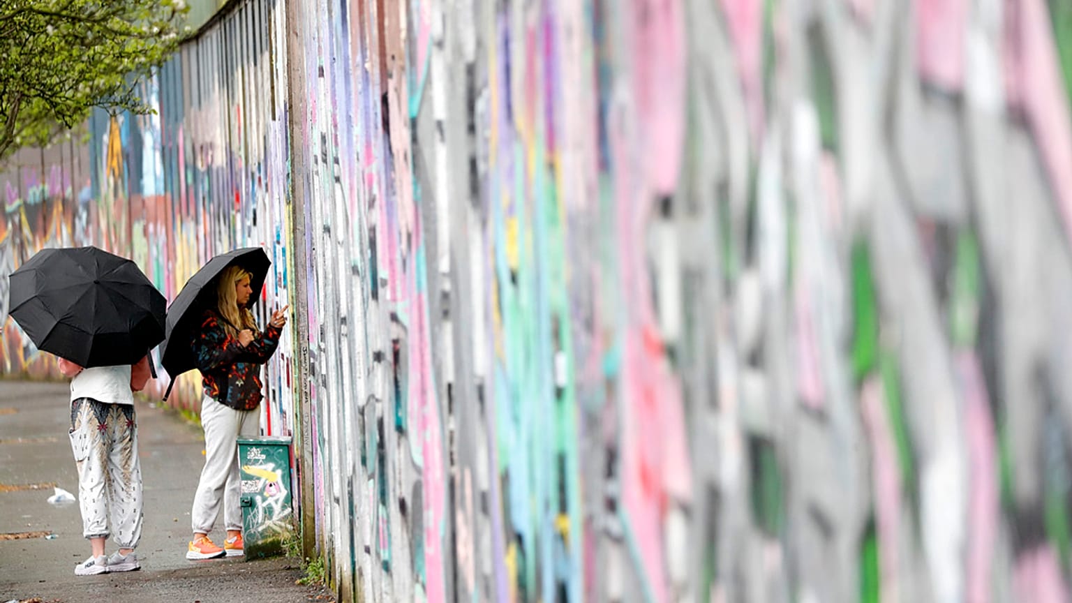 Tourists sign the “peace walls” that still separate some nationalist and unionist neighborhoods in west Belfast, Northern Ireland, Wednesday, April 5, 2023.