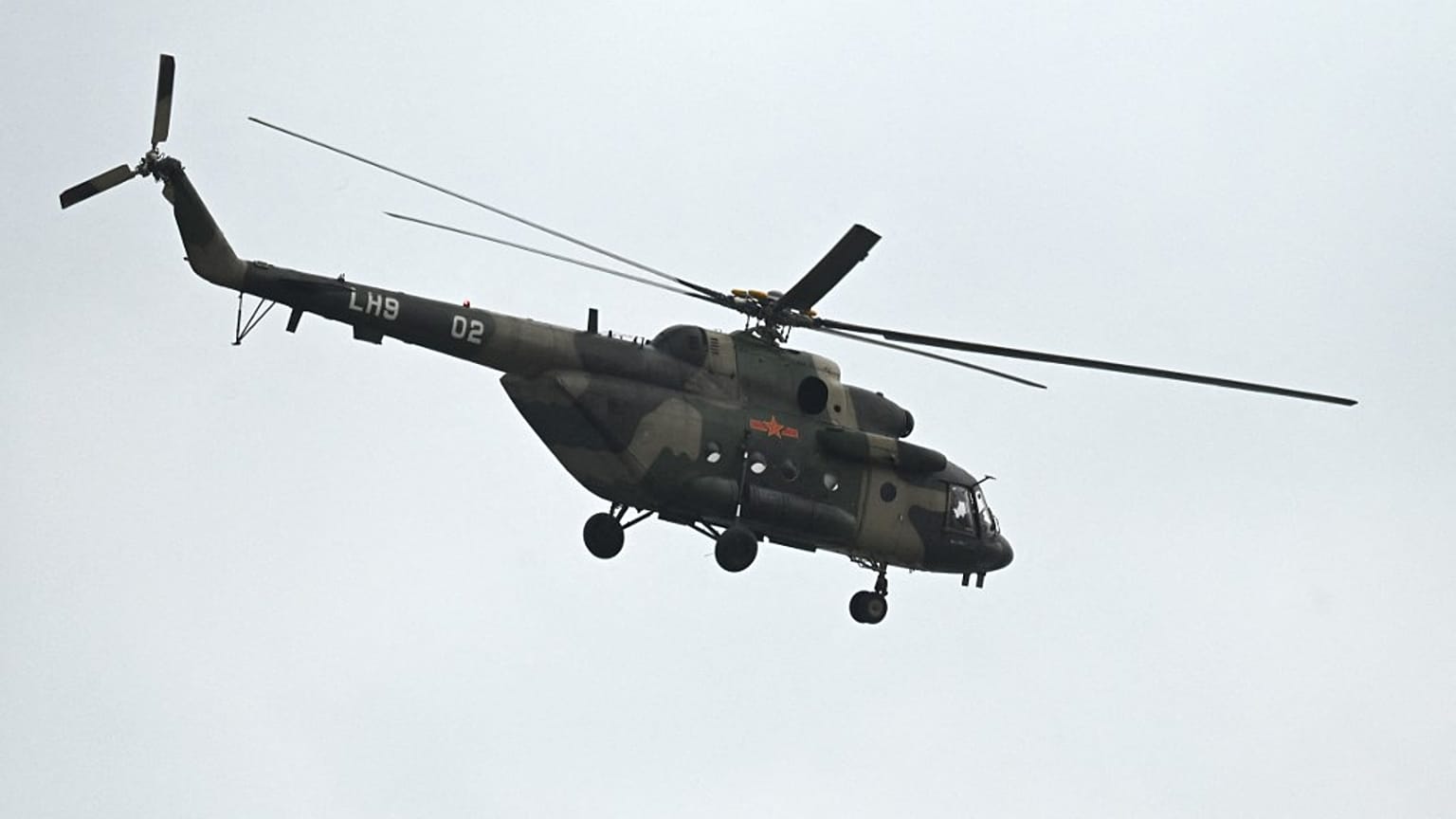 A Chinese military helicopter flies over Pingtan island, the closest point to Taiwan, in China's southeast Fujian province on April 7, 2023.