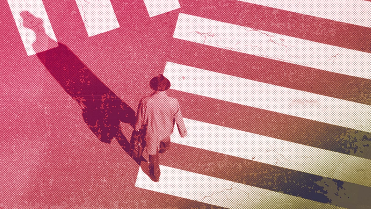 A man walks along a pedestrian crossing, January 2022