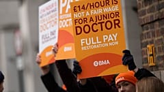 FILE - Junior doctors hold placards on a picket line outside St Mary's Hospital in London, Tuesday, March 14, 2023.