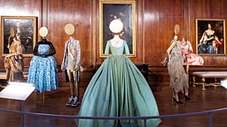 A view of the Queen's Gallery displaying costumes at the Crown to Couture exhibition