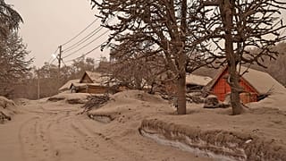 In this photo provided by the Russian Academy of Sciences' Volcanology Institute, volcanic ash covers the ground and houses after the Shiveluch volcano's eruption.