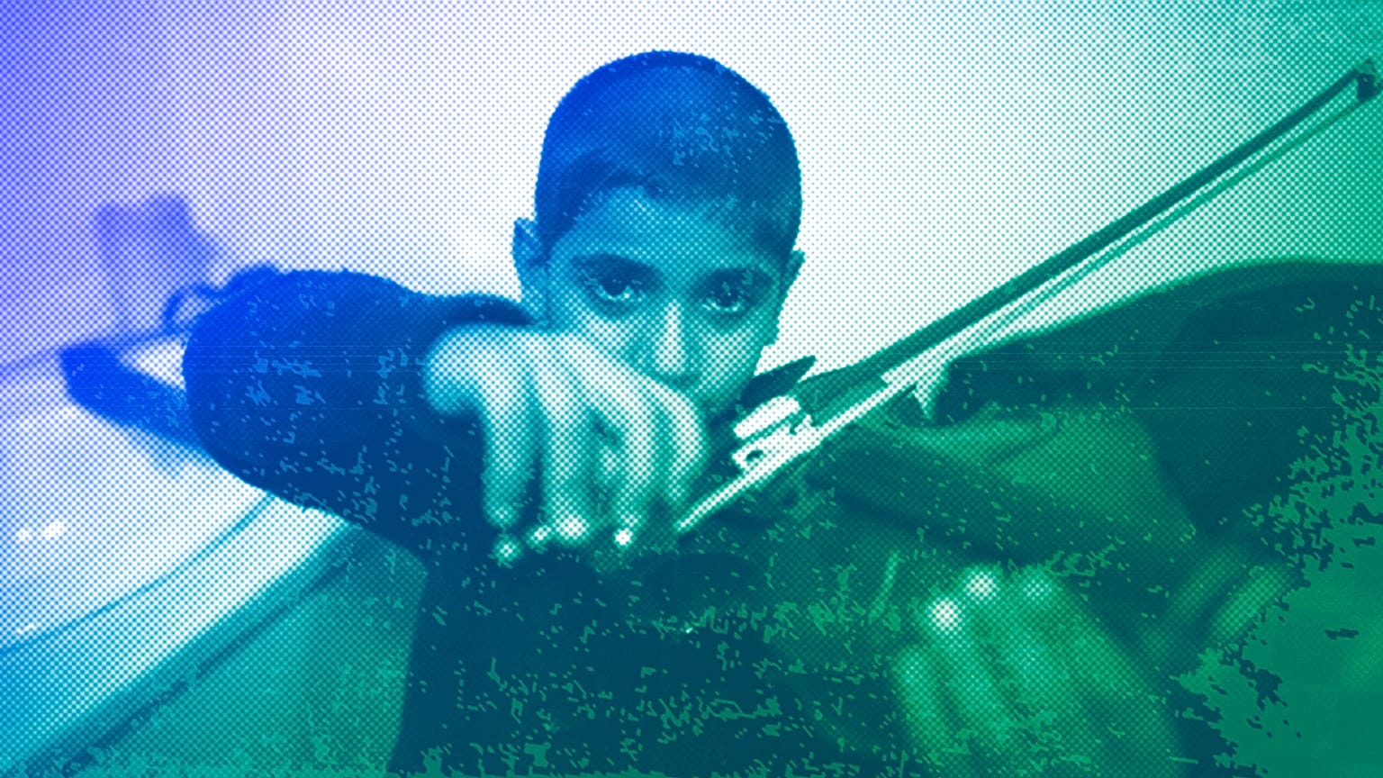 Jouan, a 10-year-old refugee from Aleppo, plays the violin as he practises backstage prior to a concert in Mytilene, Lesbos, December 2016