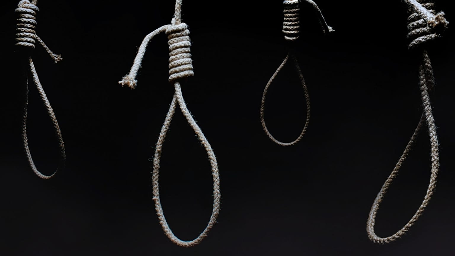 Nooses in an dark room.