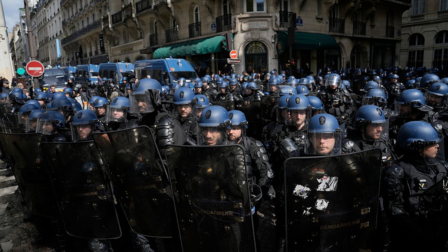Riot police officers take position during a demonstration, Thursday, April 13, 2023 in Paris.