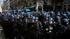 Riot police officers take position during a demonstration, Thursday, April 13, 2023 in Paris.