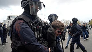 A protester is detained during a demonstration Thursday, April 13, 2023 in Paris.