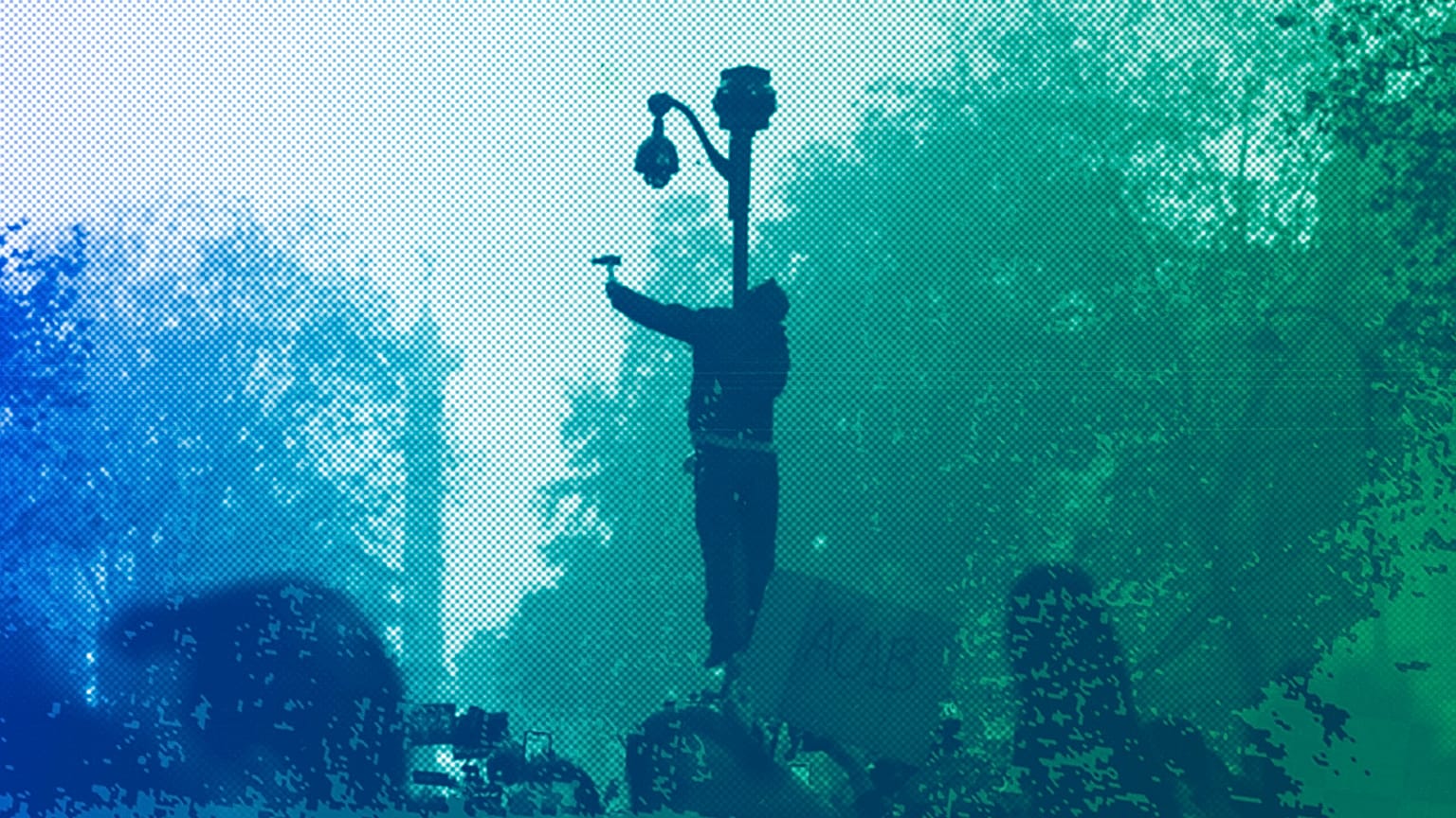 A protester uses a hammer to break a CCTV camera during a demonstration against a security law that would restrict sharing images of police in Paris, November 2020