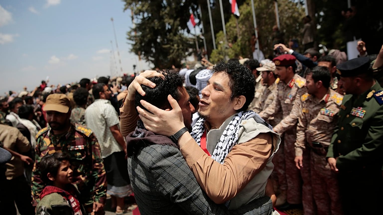 Houthi prisoners are greeted as they arrive to Sanaa airport.