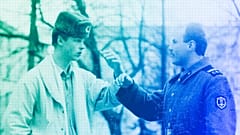A soldier explains to a young man he would prefer to be a civilian during a street discussion in Vilnius, 26 March 1990