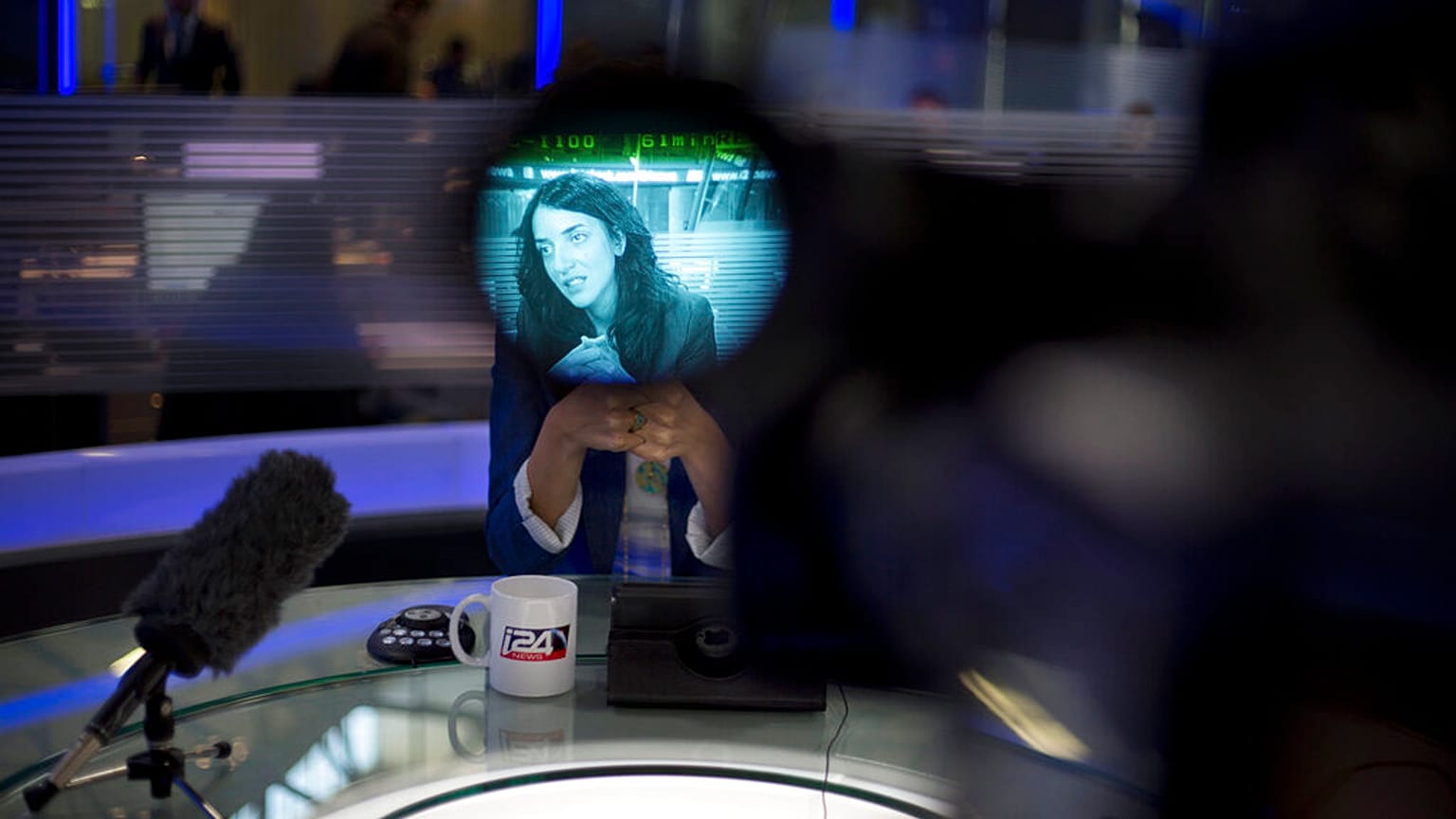 In this Sunday, April 13, 2015 photo, Arab newscaster Lucy Aharish, seen through a viewfinder, speaks during an interview